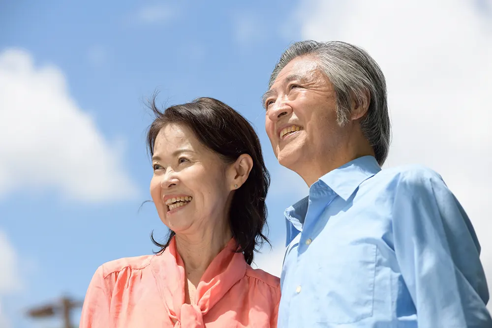 笑顔で寄り添う高齢の夫婦